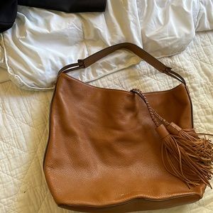 Barely used Rebecca minkoff purse. Brown Tassels, magnet clasp, interior pockets